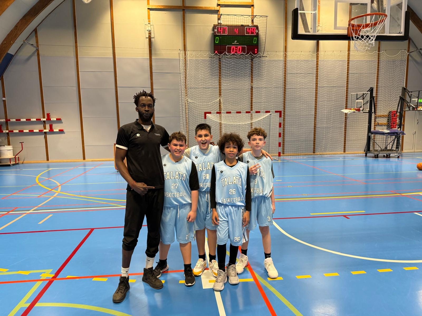 Coach Deng with the Talata Junior group after a game