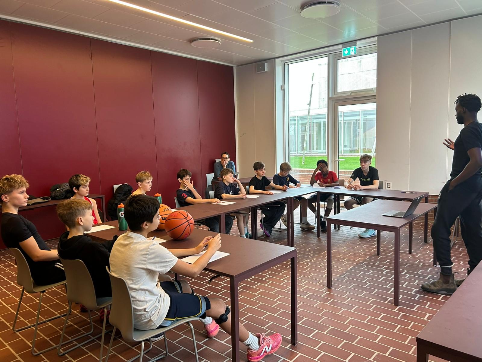 Talata team meeting around the tables before a session