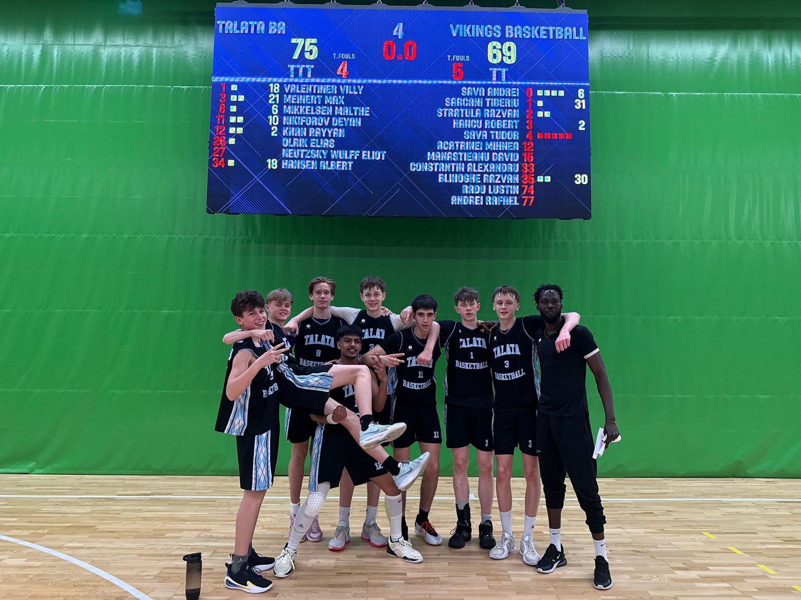 Talata team under the scoreboard after a 75 to 69 win