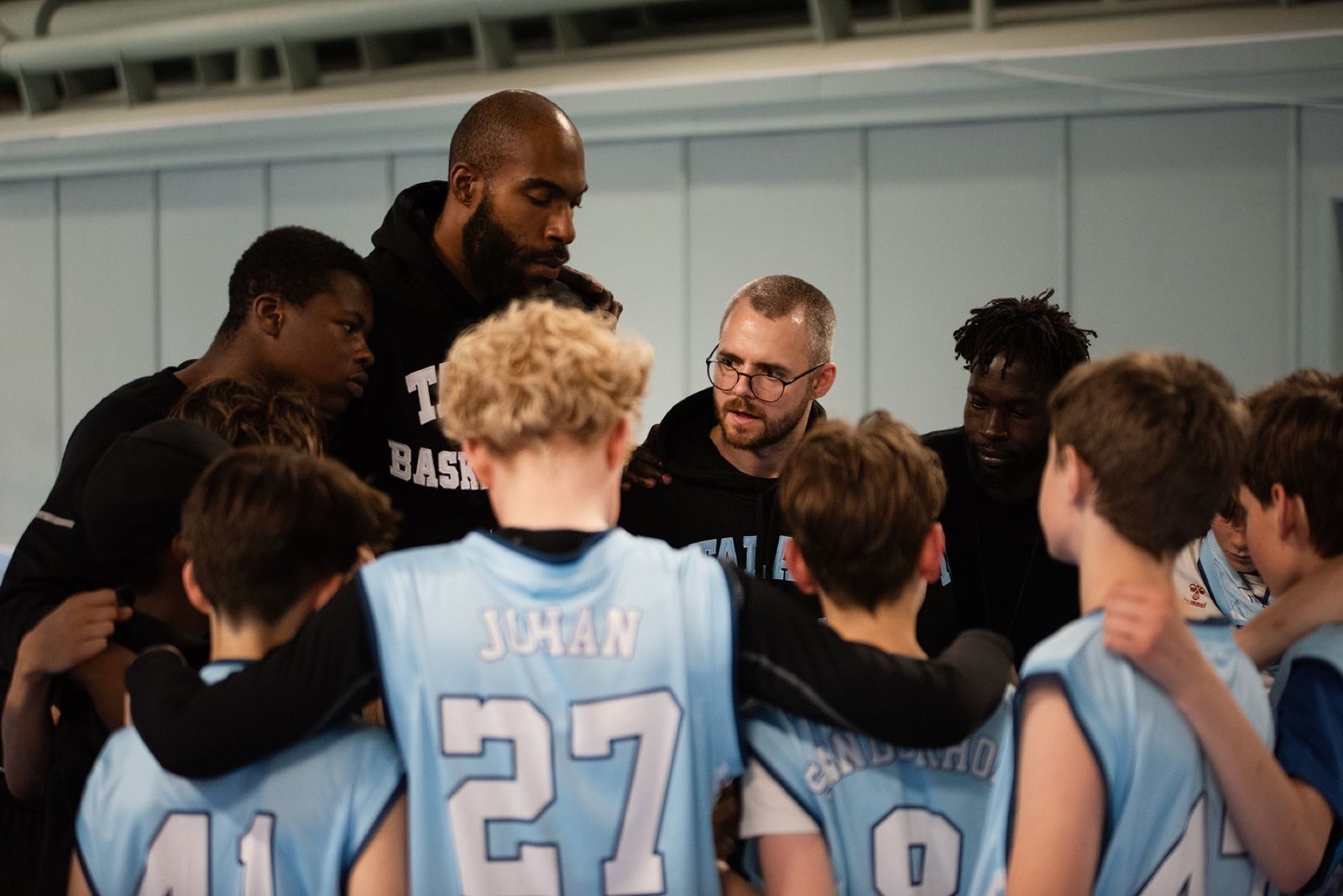 Talata coaches leading a timeout huddle