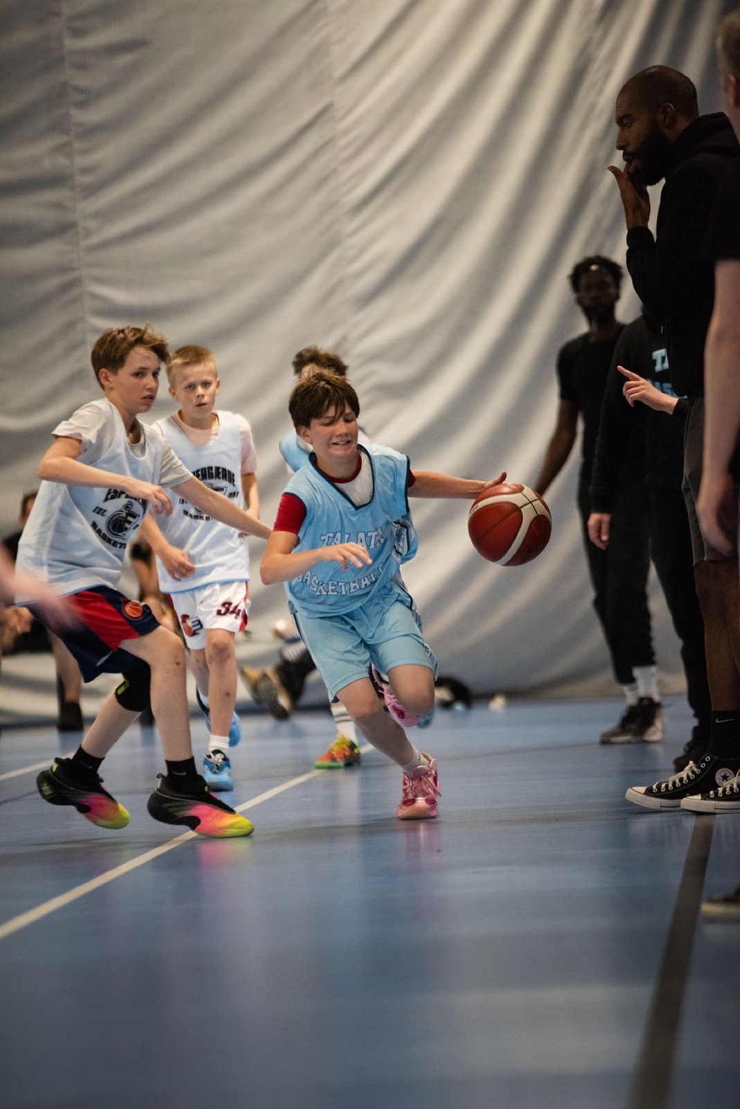 Talata player smiling on a drive past two defenders