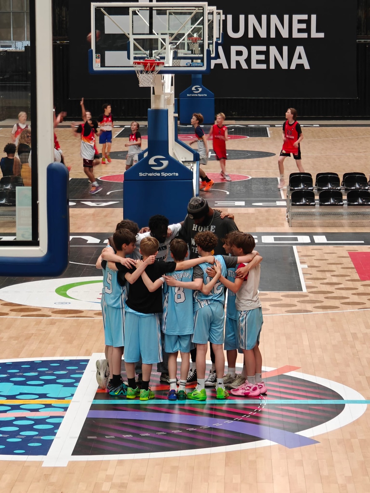 Talata team huddle on the arena court