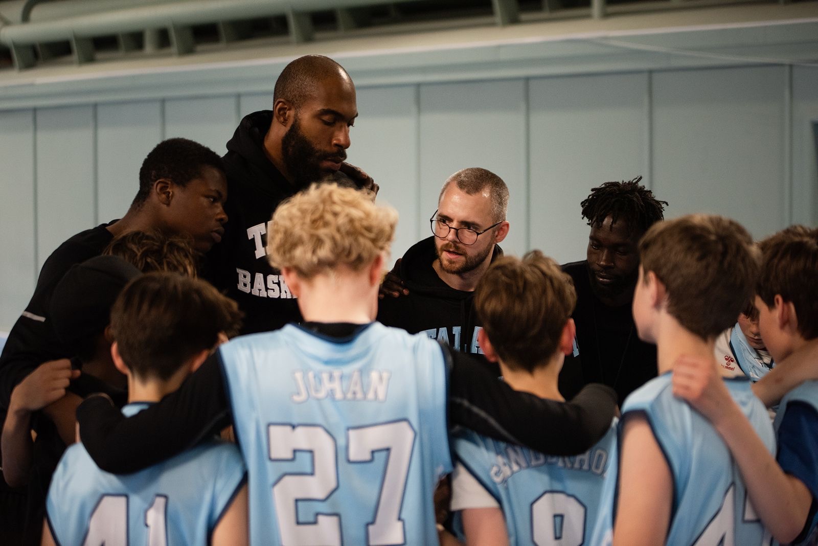 Talata coaches talking to the team in the huddle