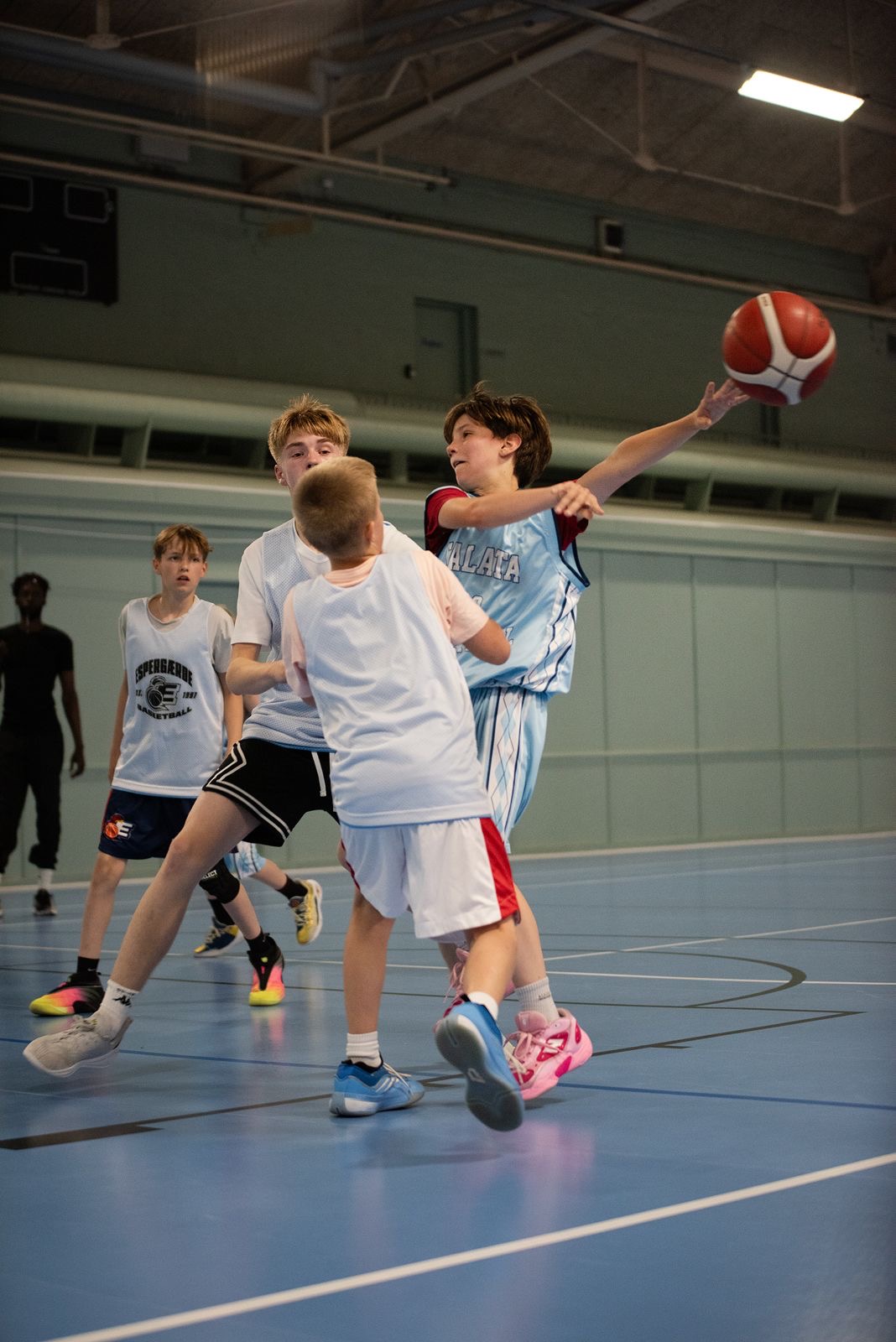 Talata U13 player finishing a contested layup
