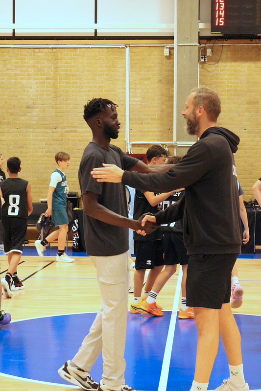 Coach Deng Awak shaking hands with the opposing coach after a game