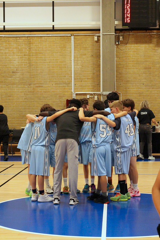 The Talata squad in a huddle on court before tip-off